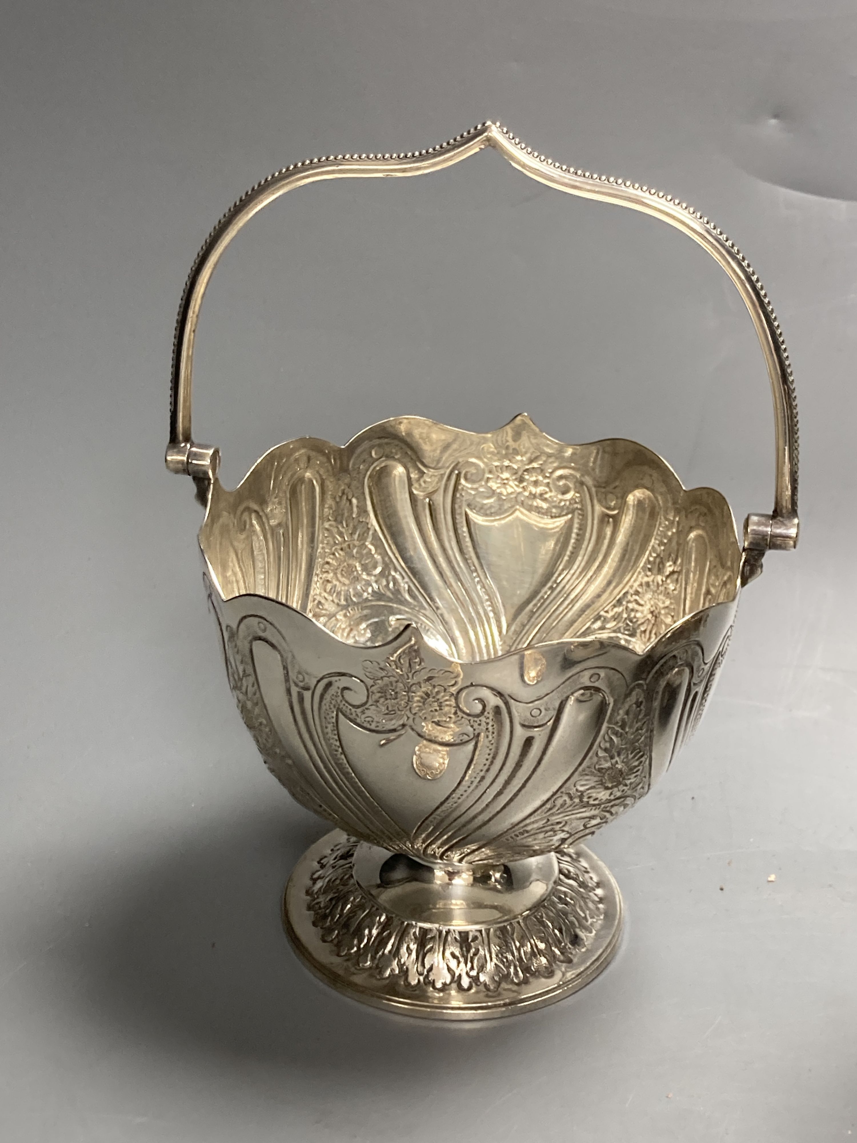 A sterling mug, a silver bonbon dish, a white metal strainer and a group of minor plated items.